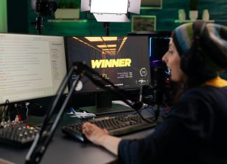 Person live streaming video games on monitor
